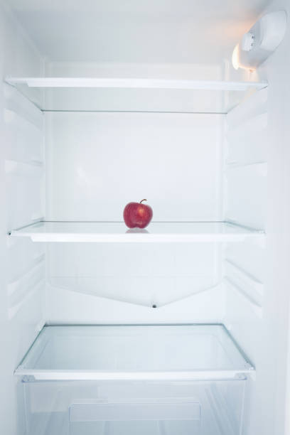 istock Close up of apple in open refrigerator 879953086
