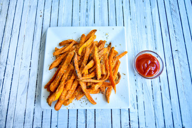 istock Sweet Potato Fries on White Table w/ Ketchup 879965258