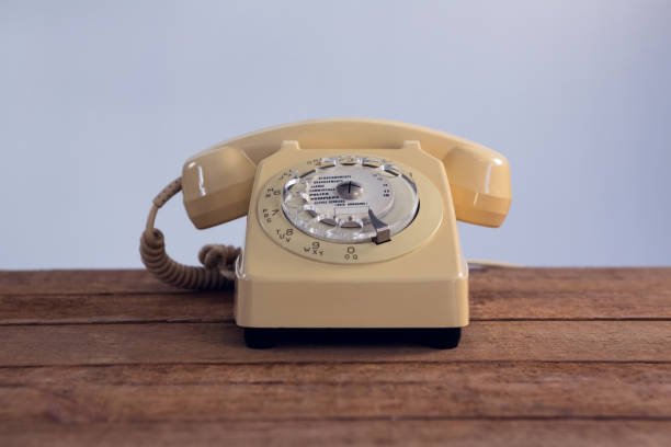 istock Vintage phone on wooden table 879969898