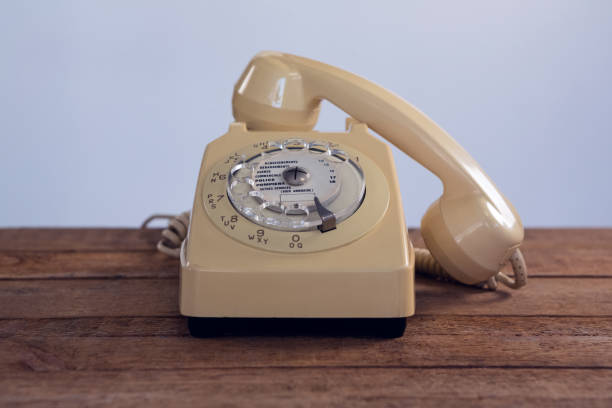 istock Vintage phone on wooden table 879969932
