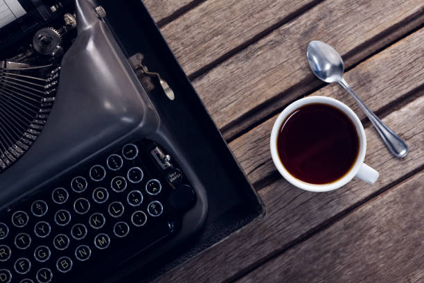 istock Vintage typewriter and cup of black coffee 879972860