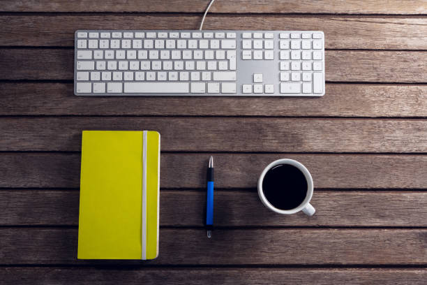 istock Black coffee, pen, organizer and keyboard on wooden table 879976862