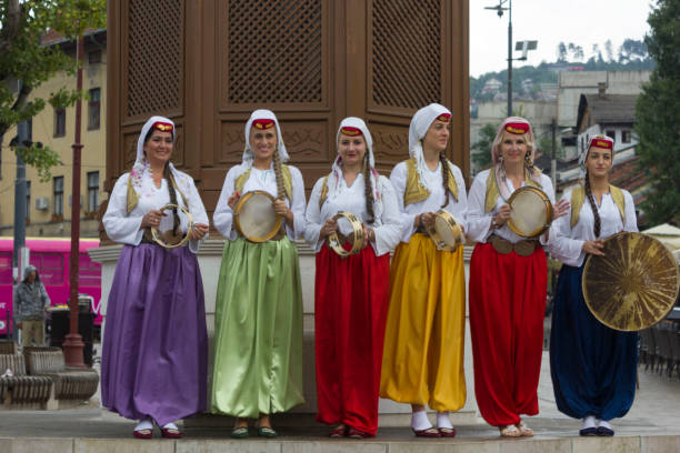 Group of traditional dressed bosnian girls Sarajevo: Group of traditional dressed bosnian girls in front of Sebilj fountain, holding tambourines bosnia and herzegovina stock pictures, royalty-free photos & images