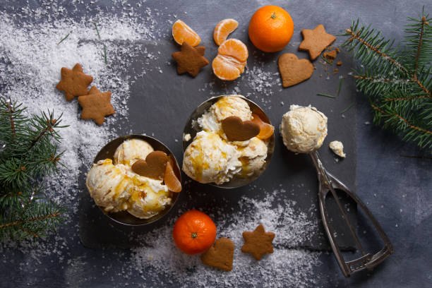 Ice cream with gingerbread, tangerine and spoon for ice cream stock photo