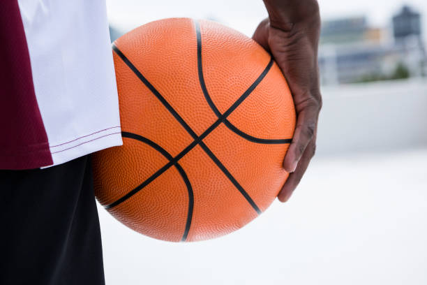 istock Player holding basketball 879989644