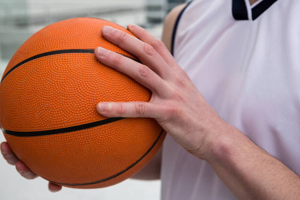 istock Player holding basketball 879994102