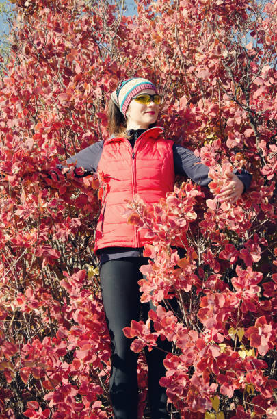 istock girl among the red foliage 880002736