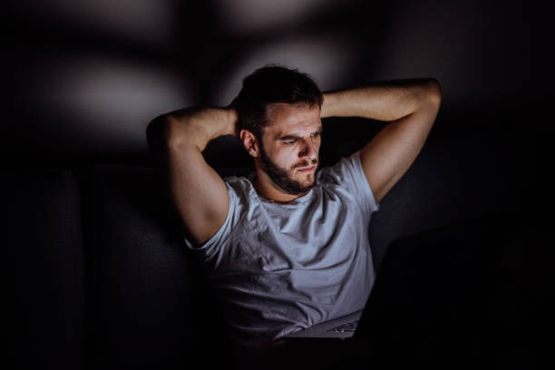 istock Man using computer late at night to trade crypto currency 880005430