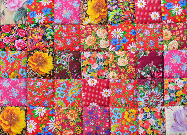 handmade patchwork quilt with flower print as background.  retro style handmade blanket or cloth wallpaper - quilt textile patchwork thread imagens e fotografias de stock