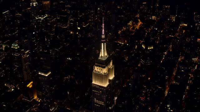 AERIAL Above the Empire State Building shining at night