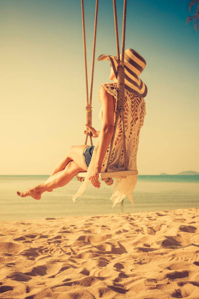 istock Woman at tropical swing 880025670