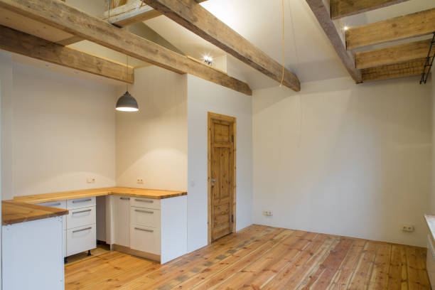 Wooden design. Room studio with a kitchen. oden beams and floor to ceiling as a design element.