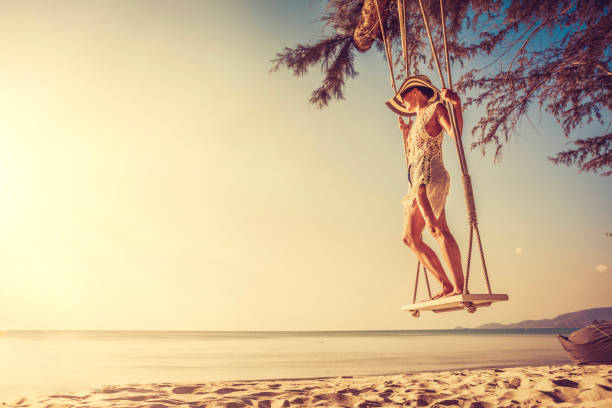 istock Woman at tropical swing 880026174