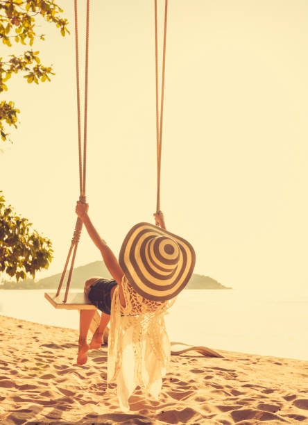 istock Woman at tropical swing 880026308