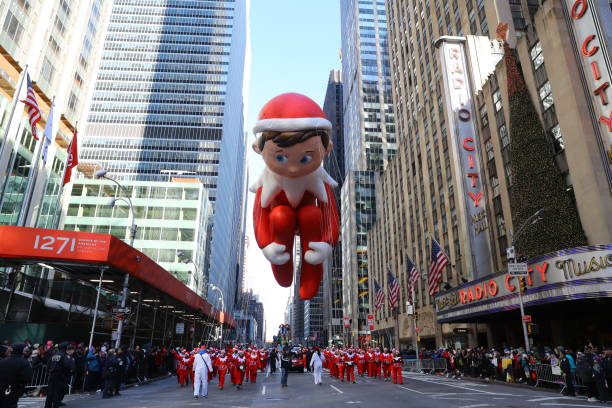 Macy's Thanksgiving Day Parade The Elf on the Shelf balloon is led down Sixth Avenue just in time for the holiday season during the 91st Macys Thanksgiving Day Parade in New York, Nov. 23, 2017. (Photo: Gordon Donovan) book title stock pictures, royalty-free photos & images