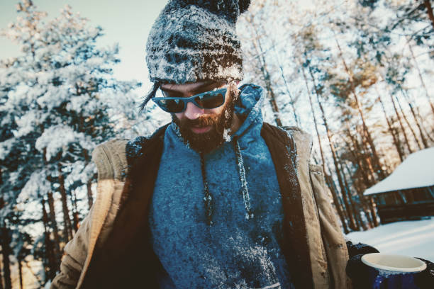 istock Frozen hipster man on snowy mountain 880056474