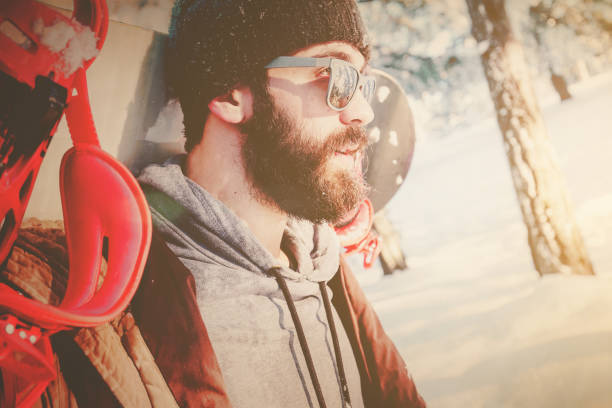 istock Hipster man with snowboard on mountain 880056504