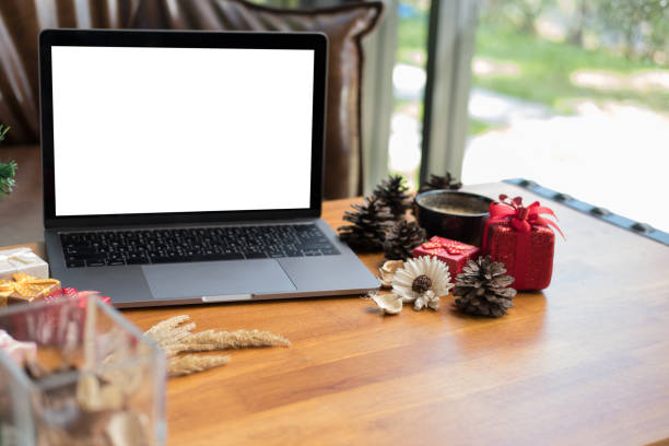 istock computer, xmas gift box on wood table. christmas and new year holiday celebration. 880057100