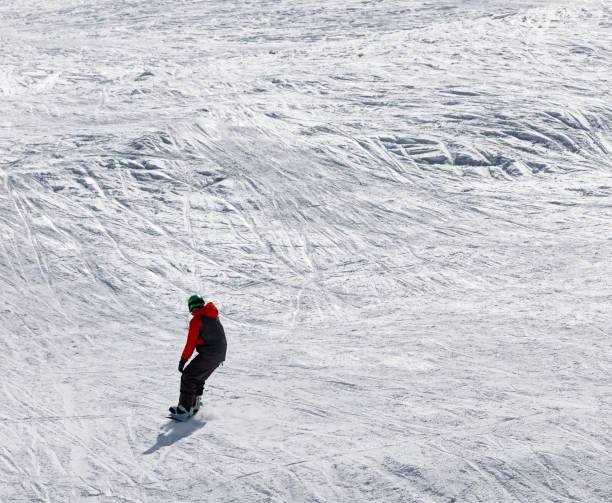 istock Snowboarder downhill on snowy off-piste slope 880057320