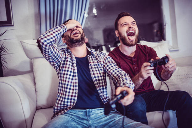 istock Handsome Man Is Defeating His Older Brother in Video Games 880129008