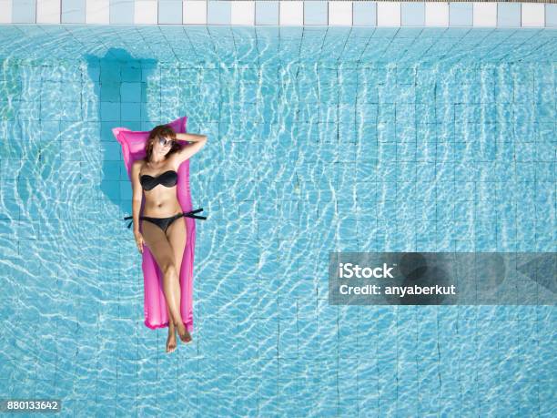 Woman In Bikini Relaxing On Inflatable Mattress In The Swimming Pool Stock Photo - Download Image Now