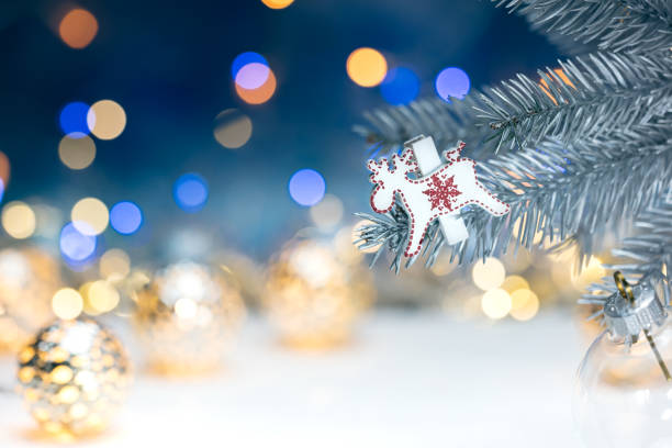 istock christmas tree decorations on fir branch against blurred background with lights 880167546