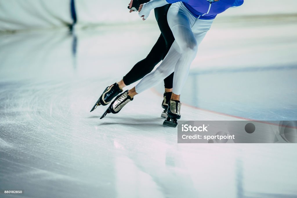 feet man athletes skater on ice go ice Palace of sports. competitions indoors. warm-up Ice-skating Stock Photo