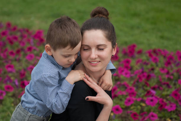istock loving mother and her tender little boy embracing 880195534