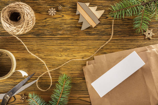 istock Packing a smartphone for a gift. The mess on the table. Place for text. The view from the top. Dark background, wood 880200596