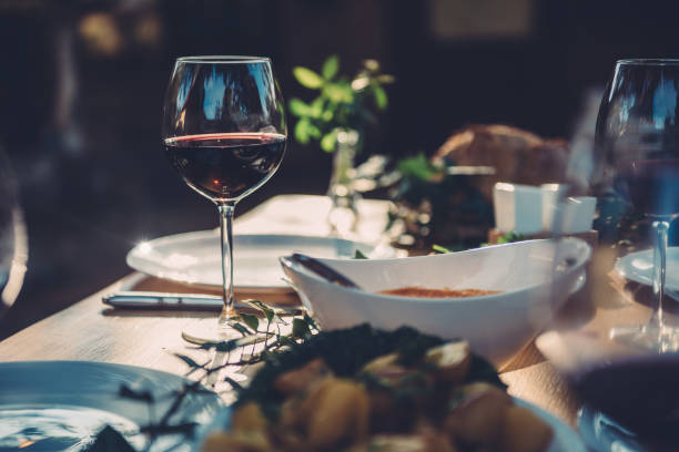 istock Glass of wine at dining table 880205150