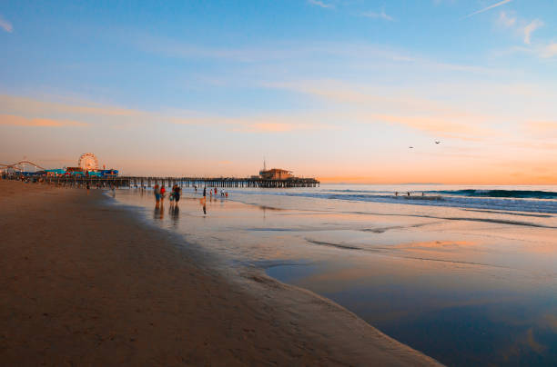 istock Santa Monica beach at sunset with people and pier view 880207602