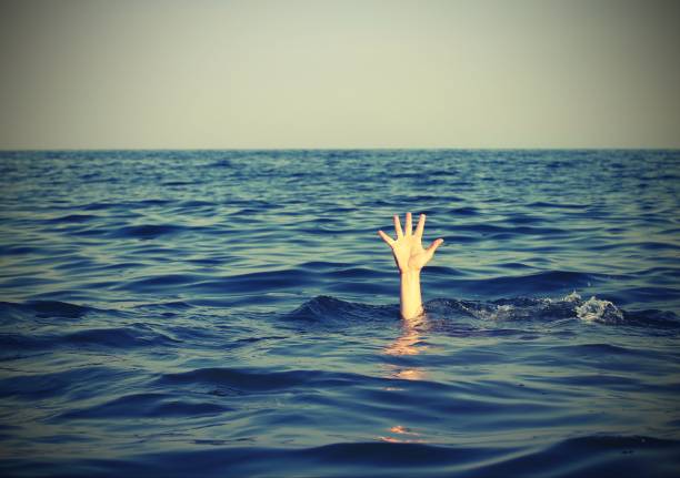 istock man while asking for help drowning in the sea with vintage effec 880207762