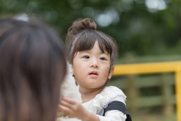 istock Mother and daughter playing in the park 880213532