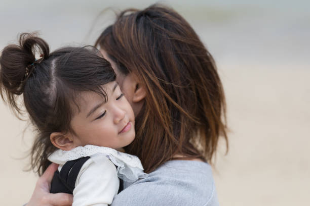 istock Mother and daughter playing in the beach 880213714