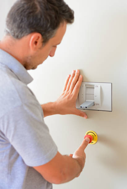 istock Electrician is turning on emergency stop button 880226662