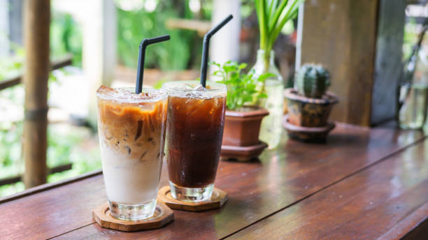 istock iced latte and americano coffee on a wooden table. 880229974