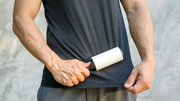 istock Man holding a hair removal roller. 880232284