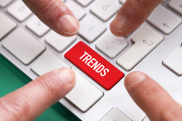 istock Computer Keyboard Concept: Many fingers pushing red TRENDS keyboard button 880272462