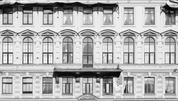 istock Toned image. Facade of an old building with large Windows and dilapidated walls 880288004
