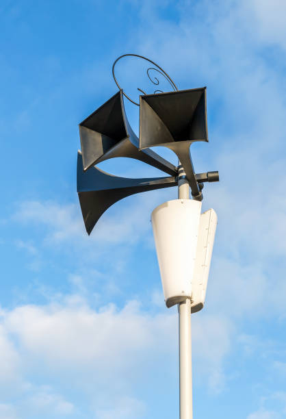 istock Old retro loudspeakers on the pole against the blue sky 880290704