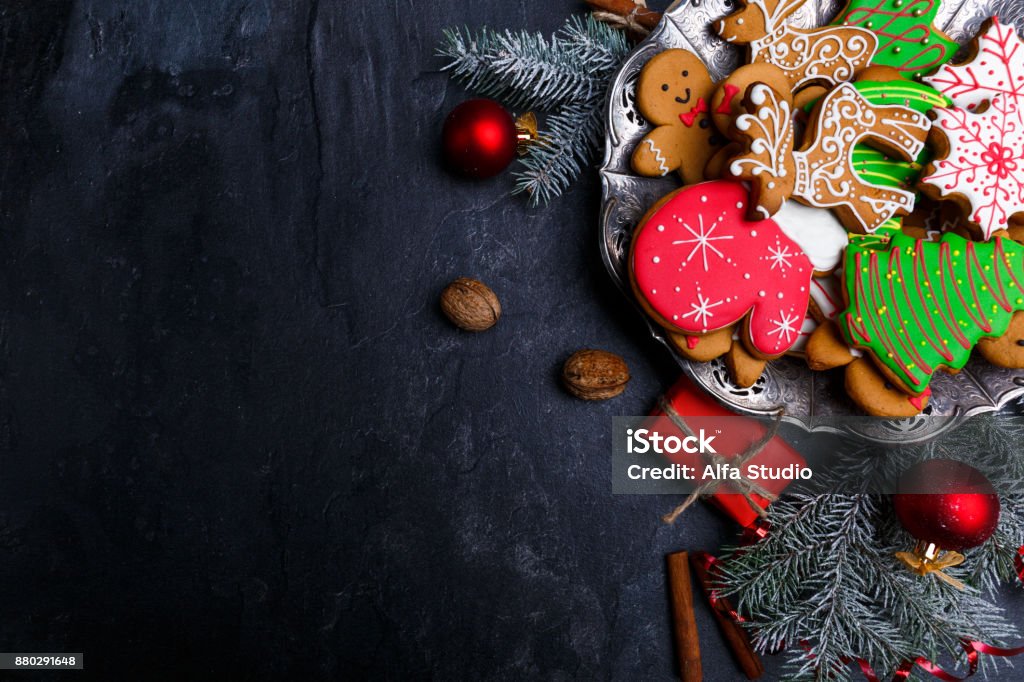 Dark background and with a layout in the corner of a Christmas cookie. View from above. Dark background with place for inscription and with a layout in the corner of a Christmas cookie. View from above. Indoors. Vacations Stock Photo