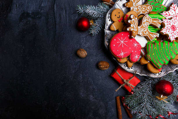 Dark background and with a layout in the corner of a Christmas cookie. View from above. Dark background with place for inscription and with a layout in the corner of a Christmas cookie. View from above. Indoors. christmas cookies stock pictures, royalty-free photos & images