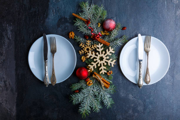istock Two plates and between them Christmas tree is decorated with snowflakes, balls and cinnamon sticks. 880294294