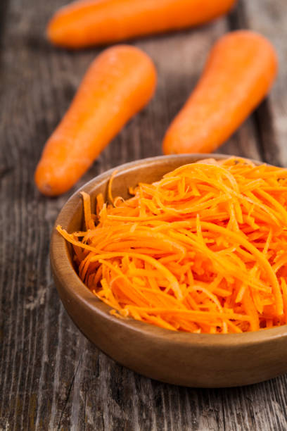 istock Grate  carrots in a bowl 880294392