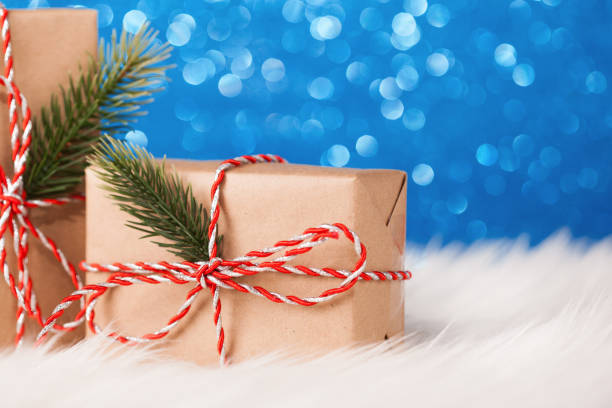 istock Christmas kraft gift on blue background 880297626