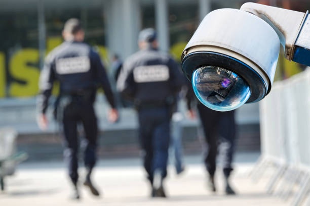 security CCTV camera or surveillance system with military on blurry background