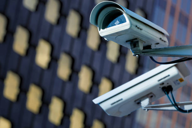 istock cctv security camera in a city with blury business building on background 880300426