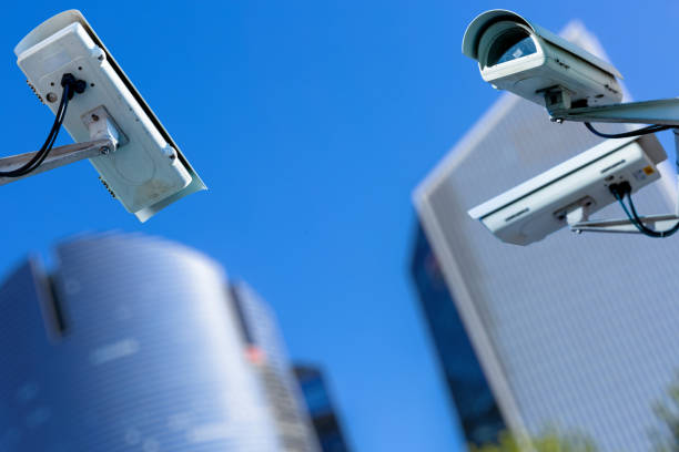istock two cctv security camera in a city with blury business building on background 880300446