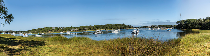 motorboats at the bay in Chatham, Cape Cod with reed grass