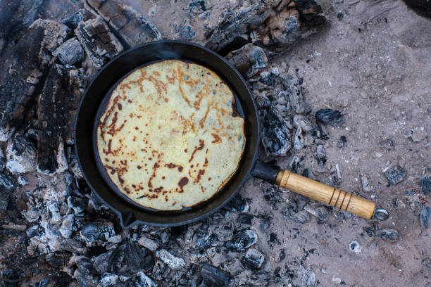 istock Cooking pancakes on the fire in the forest. 880305130